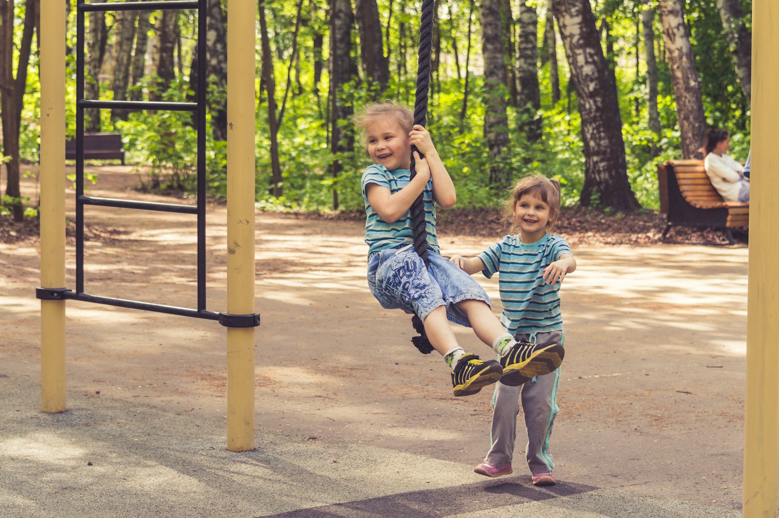 Children playing on a swing
